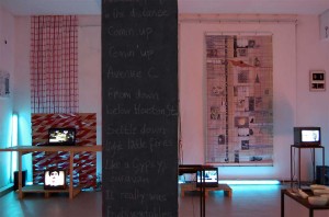 installation view: written text on column • LCD screens • drawing